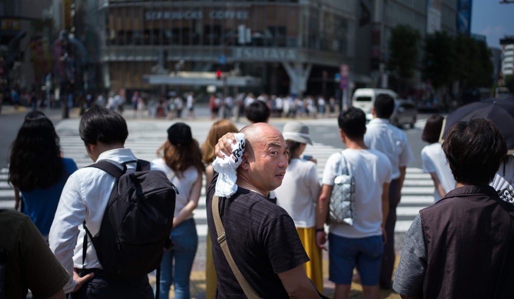 A man wipes perspiration from his head in Tokyo, as Japan suffers an “unprecedented” heatwave, on July 24. The Japanese weather agency classified the record-breaking weather as a “natural disaster”, with 65 people dead within a week, shortly after devastating floods killed hundreds. Photo: AFP