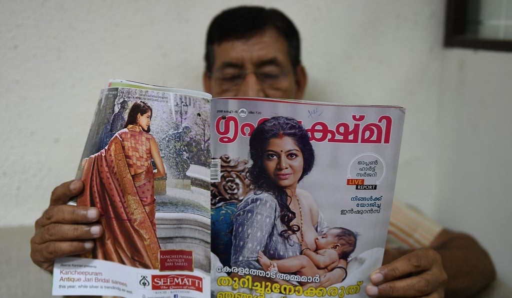 A man reads a magazine in New Delhi featuring Kerala actress Gilu Joseph. Photo: AFP