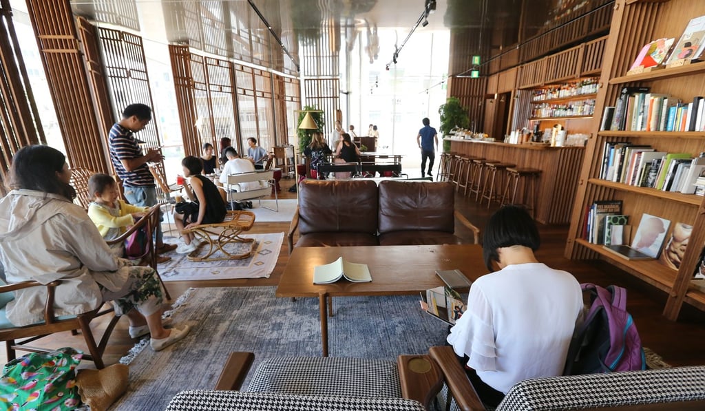 Visitors to the Central Police Station Compound heritage site sit and read in the art library, which is in the Old Bailey Restaurant. Photo: Dickson Lee