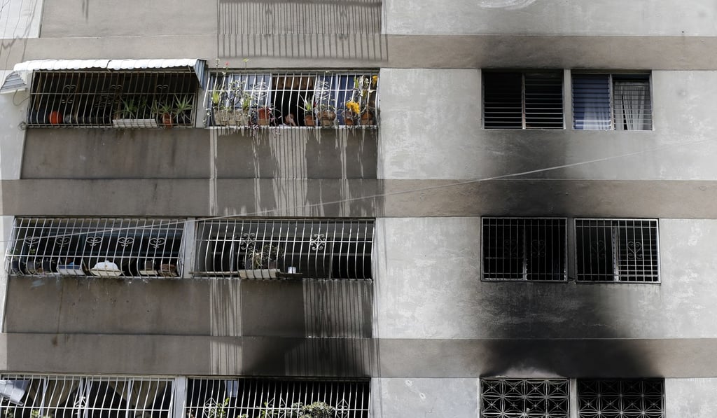Smoke stains on the apartment complex where an armed drone crashed, causing a fire, in Caracas, Venezuela. Photo: AP Smoke stains on the apartment complex where an armed drone crashed, causing a fire, in Caracas, Venezuela. Photo: AP