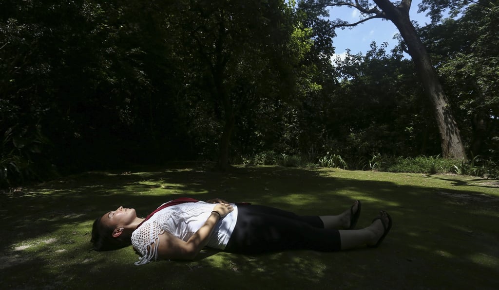 Jasmine Nunns relaxes in Shek Kip Mei. Nunns leads nature walks for people of all ages, to help them reconnect with the outdoors and relieve stress. Photo: Jonathan Wong