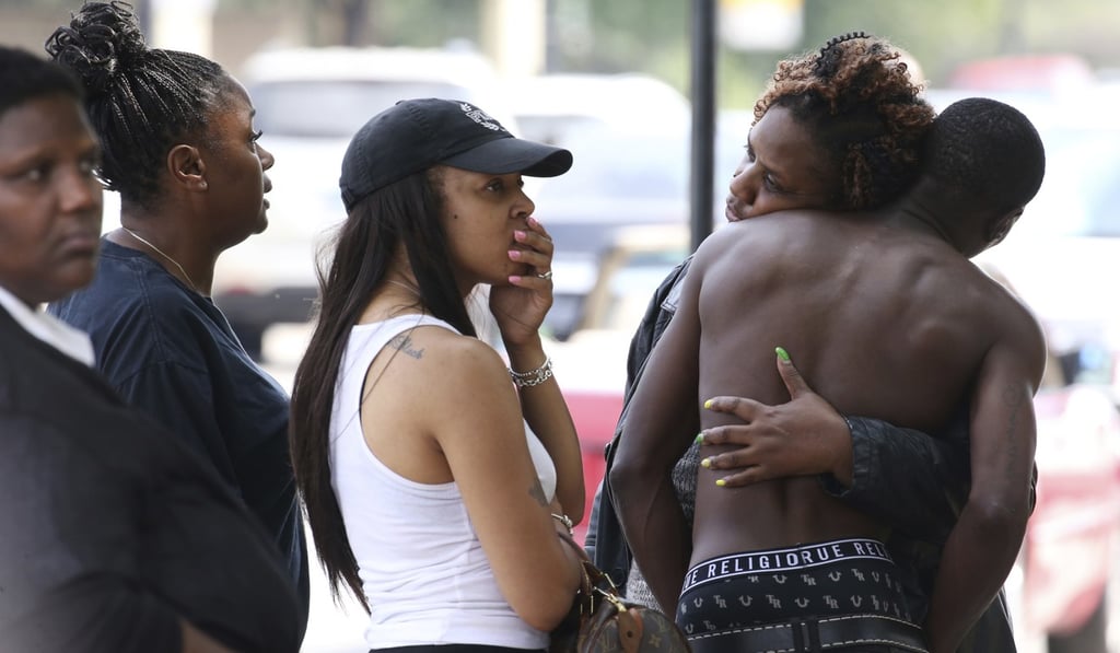 People who were forced outside or asked to leave, from the Stroger Hospital emergency waiting room area in Chicago, due to overwhelming crowds of family and friends of shooting victims on Sunday. Photo: AP