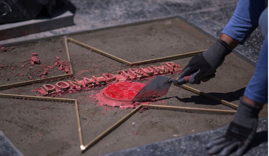 In this file photo taken on July 25, workers replace the star of US President Donald Trump on the Hollywood Walk of Fame after it was destroyed by a vandal. Photo: Agence France-Presse
