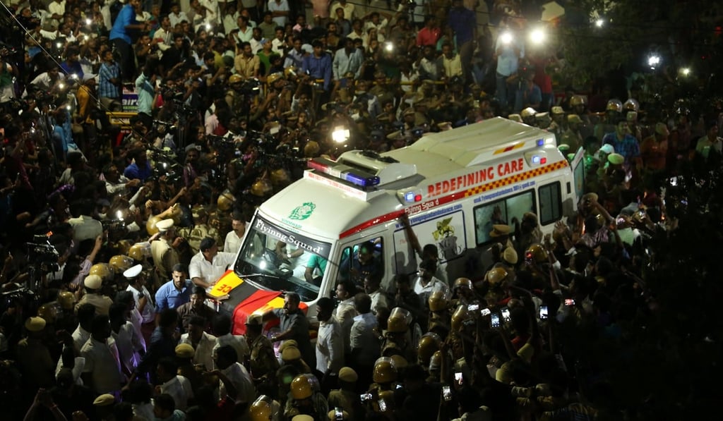 Supporters surround the ambulance carrying the remains of Karunanidhi as it leaves the hospital. Photo: Reuters