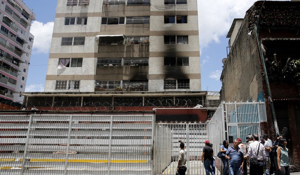 Press members wait as they try to get access to an apartment complex where an allegedly armed drone crashed, causing a fire, in Caracas, Venezuela, on Sunda, in an apparent attack on President Nicolas Maduro. Photo: AP Press members wait as they try to get access to an apartment complex where an allegedly armed drone crashed, causing a fire, in Caracas, Venezuela, on Sunda, in an apparent attack on President Nicolas Maduro. Photo: AP