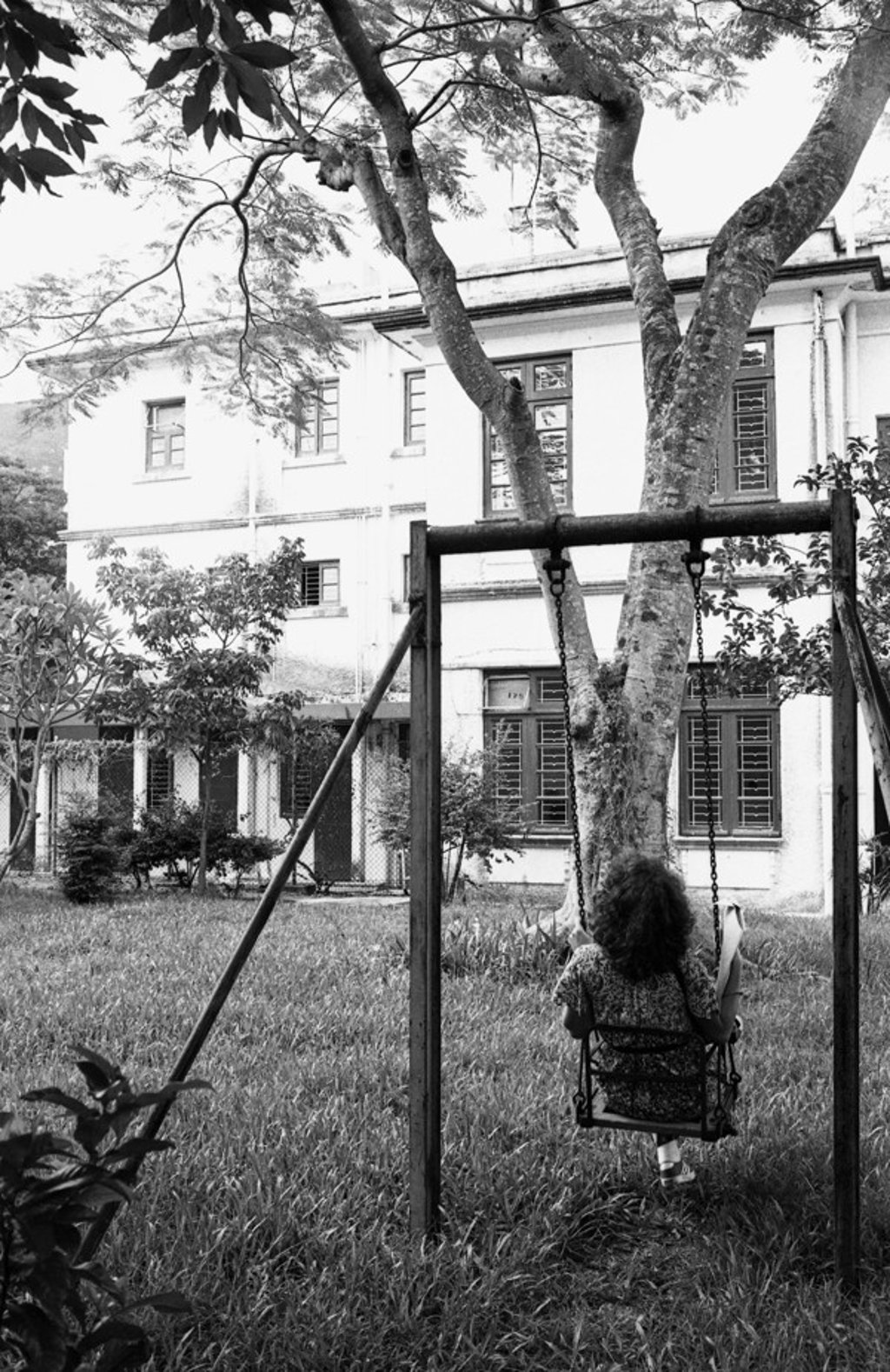 A girl on a swing in a garden on Broadwood Road in 1978. Photo: P.Y. Tang