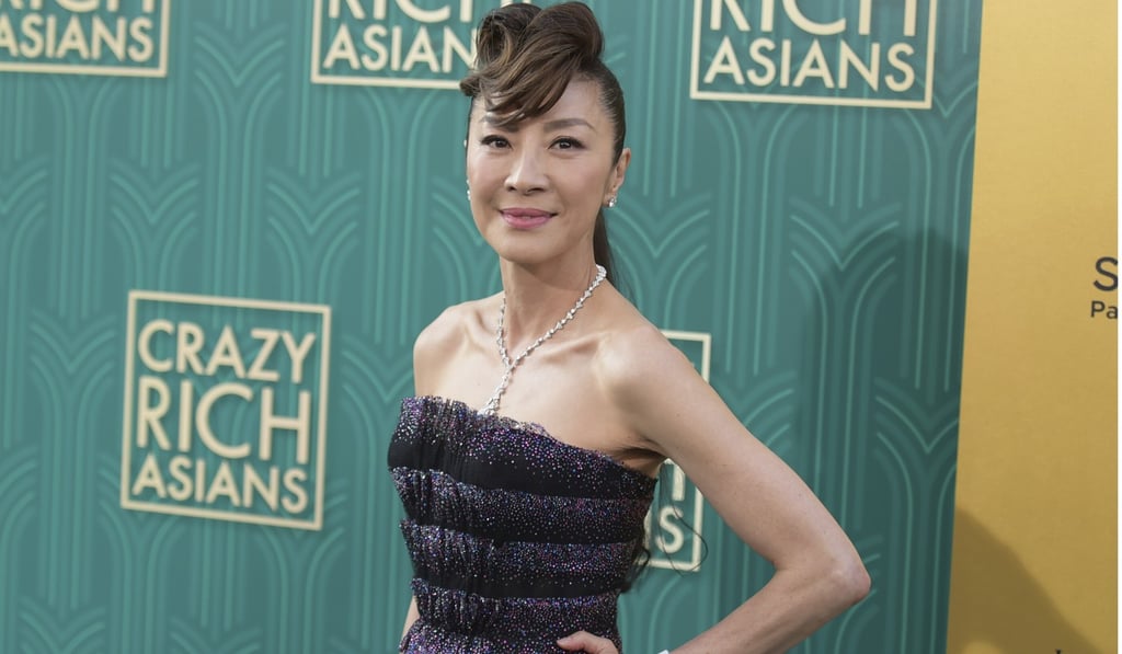 Michelle Yeoh arrives at the premiere, dazzling in an Armani dress and a Bulgari necklace. Photo: AP