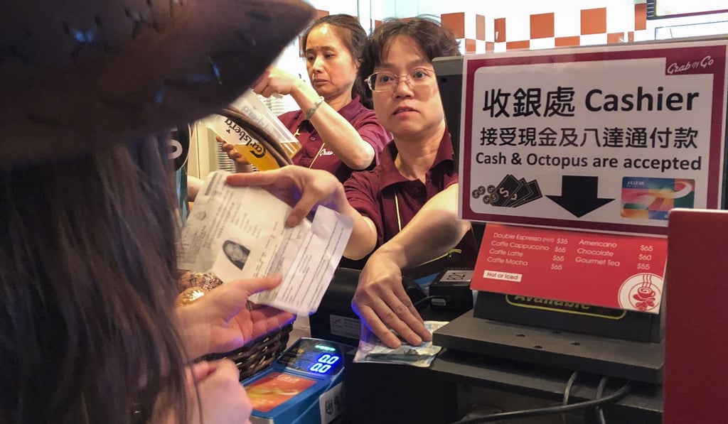 A staff member of the Hong Kong Sevens checks the ID of a customer purchasing an alcoholic beverage. Photo: SCMP