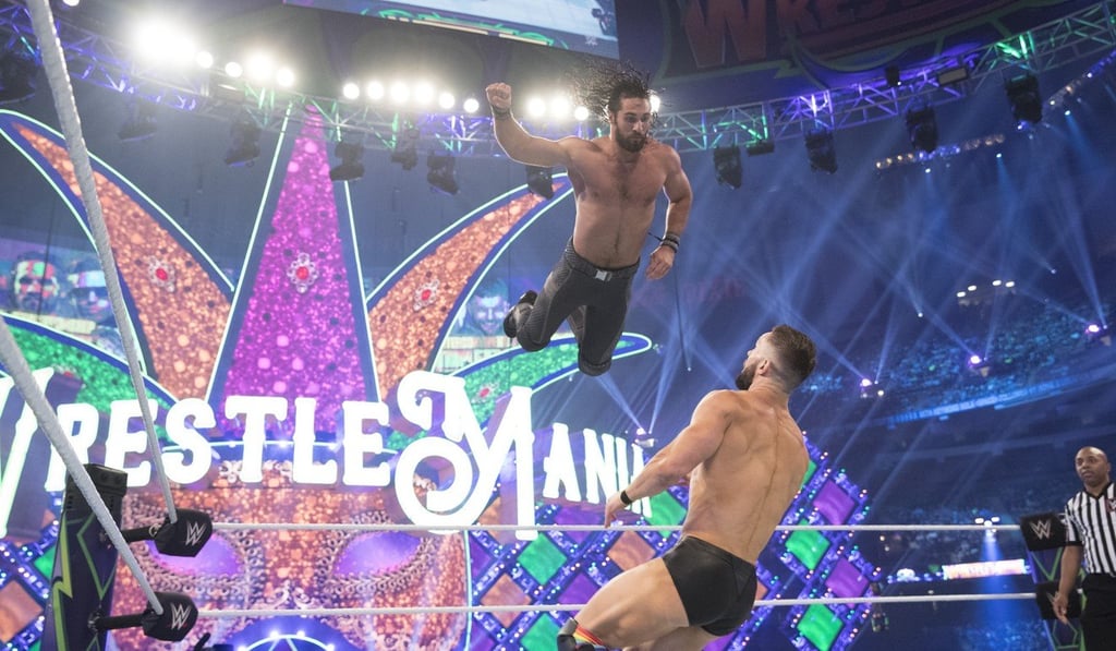Seth Rollins leaps through the air at WrestleMania 34.