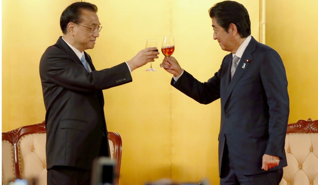 Li Keqiang (left) and Shinzo Abe raise their glasses at a reception for Li in Tokyo in May. Photo: Kyodo Li Keqiang (left) and Shinzo Abe raise their glasses at a reception for Li in Tokyo in May. Photo: Kyodo