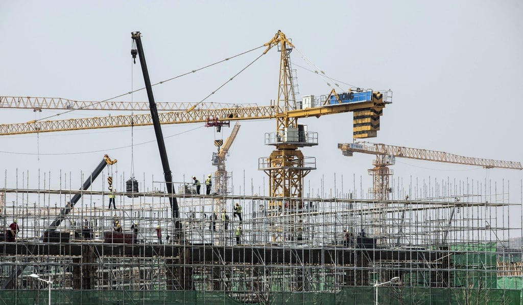 Cranes operate at residential buildings under construction at Dalian Wanda’s Oriental Movie Metropolis film production hub in Qingdao, China. Photo: Bloomberg