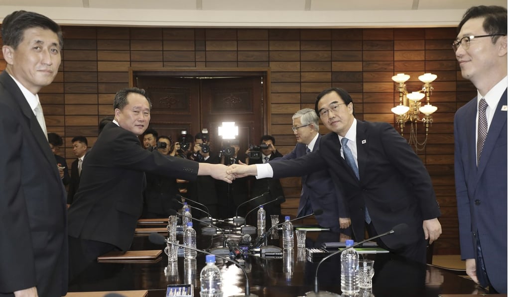 South Korean Unification Minister Cho Myoung-gyon, second from right, shakes hands with his North Korean counterpart Ri Son-gwon. Photo: AP South Korean Unification Minister Cho Myoung-gyon, second from right, shakes hands with his North Korean counterpart Ri Son-gwon. Photo: AP