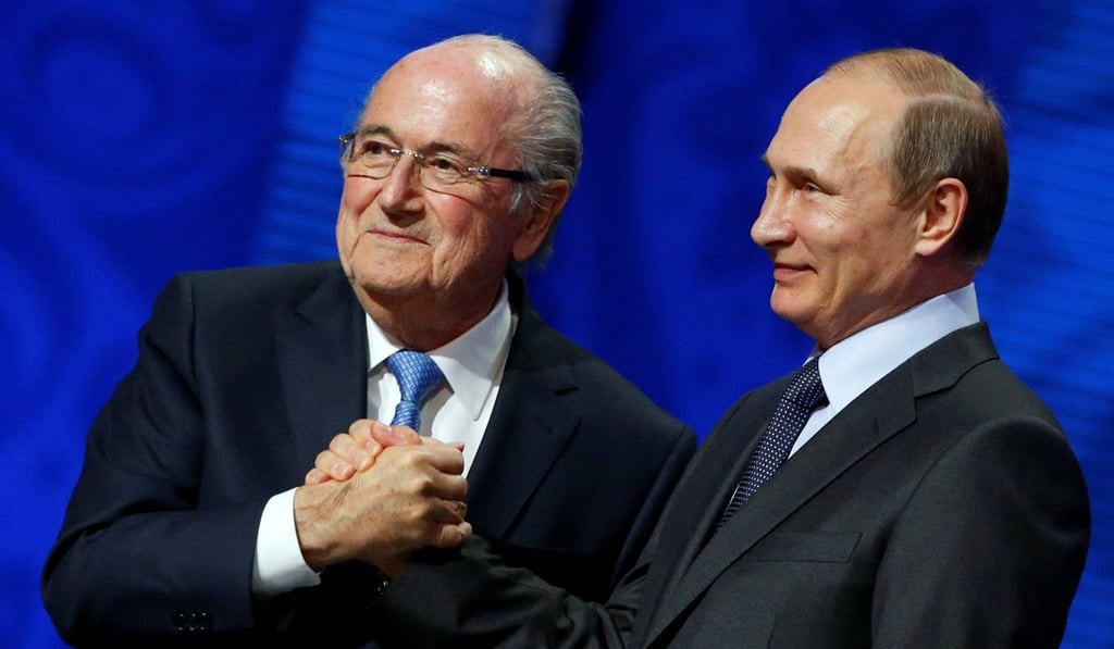 Former Fifa president Sepp Blatter shakes hands with Vladimir Putin in 2015. Photo: Reuters