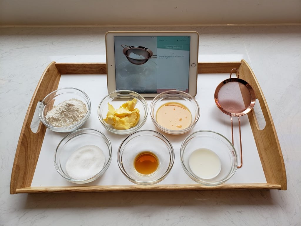 Cake batter ingredients all laid out with a tutorial guide in an app on an iPad Cake batter ingredients all laid out with a tutorial guide in an app on an iPad