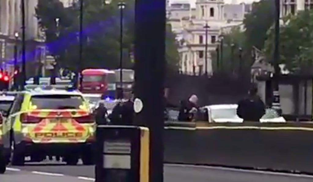 Police surrounding the silver car after it crashed. Photo: AFP/Ewalina OCHAB Police surrounding the silver car after it crashed. Photo: AFP/Ewalina OCHAB