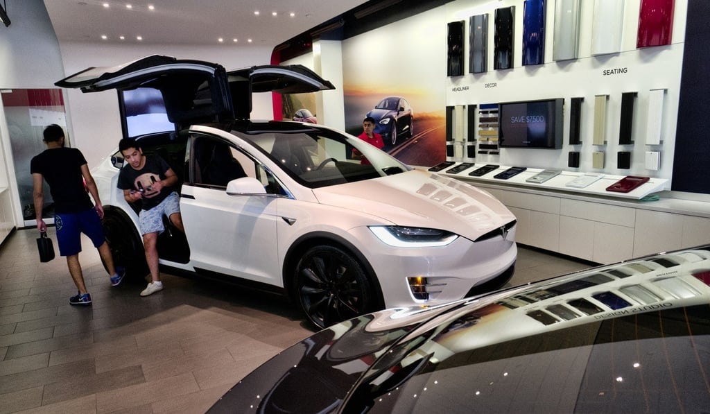 Customers looking at a Tesla X at a showroom in Santa Monica, Californina. Photo: AP