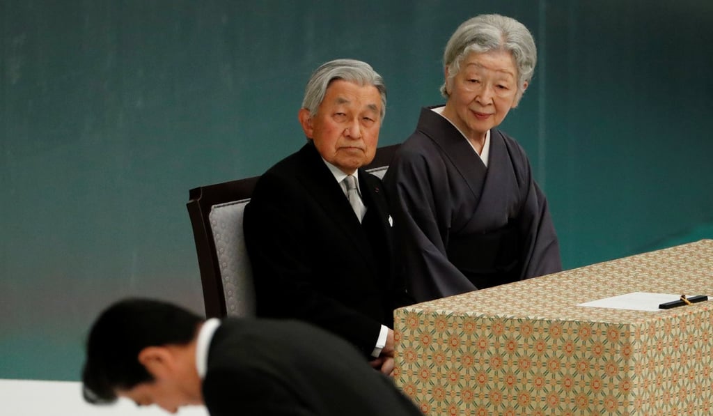 Japan's Emperor Akihito and Empress Michiko look at Prime Minister Shinzo Abe during a memorial ceremony marking the surrender. Photo: Reuters