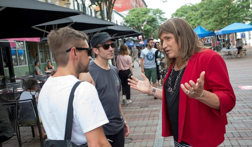 Vermont Democratic Party gubernatorial primary candidate Christine Hallquist, a transgender woman, speaks with Ben Watts and Nate Jarvis while campaigning on Church Street in Burlington, Vermont, on August 8. Photo: Reuters