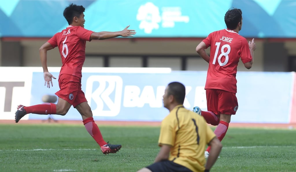 Jorge Tarres Paramo of Hong Kong (right) wheels way with teammate Tan Chun-lok after scoring against Taiwan. Photo: AFP