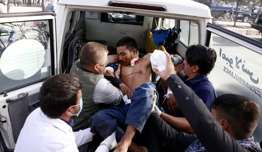 People carry Injured victims to a hospital. Photo: EPA People carry Injured victims to a hospital. Photo: EPA