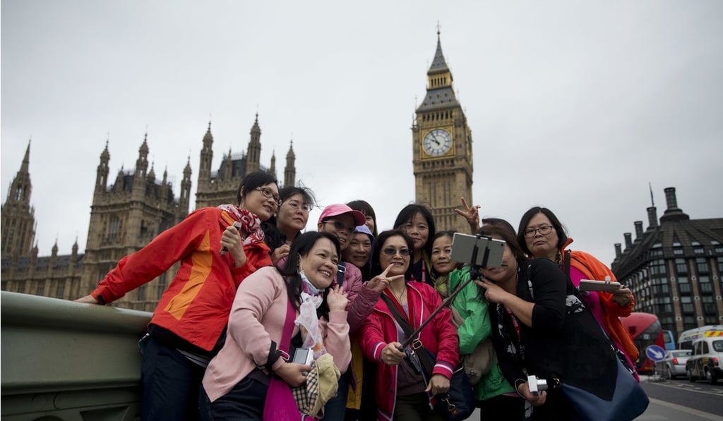 Tourists in London take a selfie with the Houses of Parliament in the background in June 2016, just before Britain voted to leave the European Union. Photo: AP