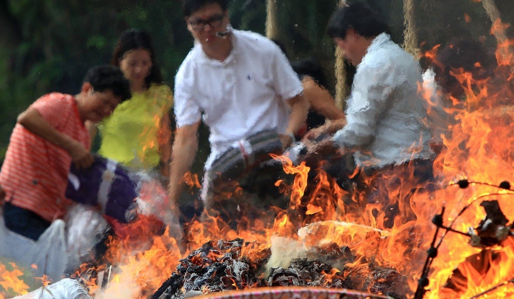 Villagers burn offerings during the Hungry Ghost Festival. Photo: SCMP