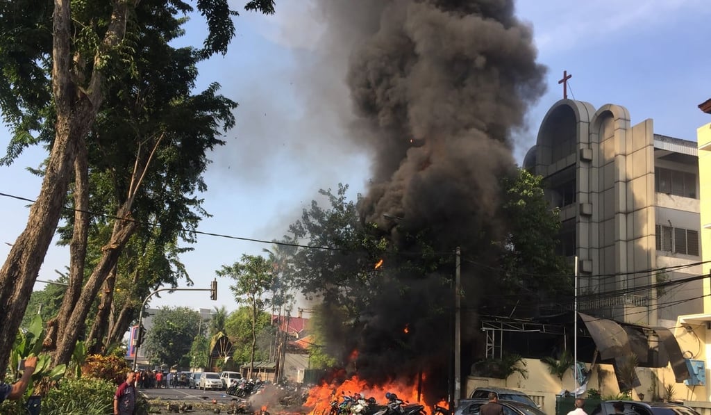 Smoke billows from the Surabaya Centre Pentecostal Church after a bomb attack on May 13. Photo: AFP