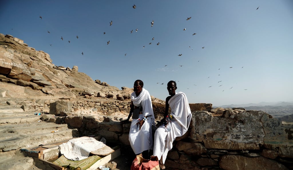 Muslim pilgrims from Somalia rest while climbing Mount Al-Noor on Saturday. Photo: Reuters