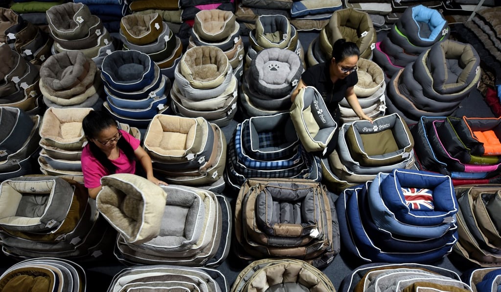 Workers sort dog beds for export in a factory in Linyi, Shandong province, China. Photo: Reuters