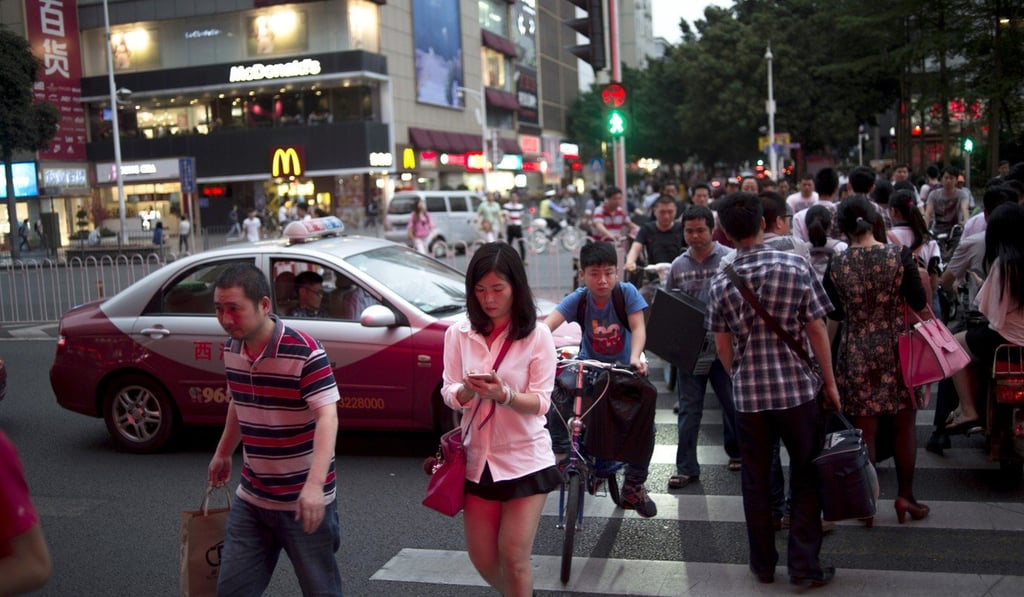 Hong Kong residents living and working on the mainland can get the smart card. Photo: AFP Hong Kong residents living and working on the mainland can get the smart card. Photo: AFP
