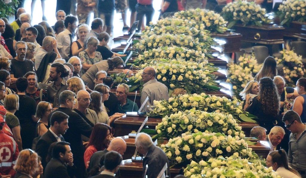 People mourn during a state funeral for victims of the bridge collapse in the northwest Italian city of Genoa, on Sunday. Photo: Xinhua
