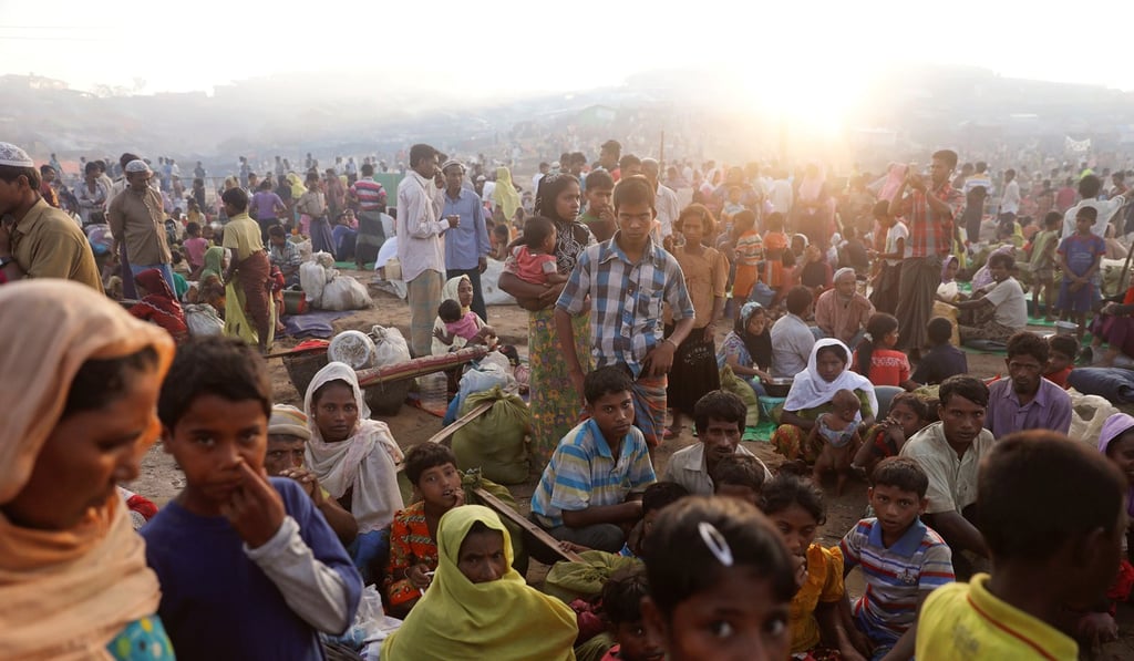 Thousands of Rohingya refugees who fled from Myanmar wait by a road where they spent the night between refugee camps, near Cox's Bazar in Bangladesh. Photo: Reuters