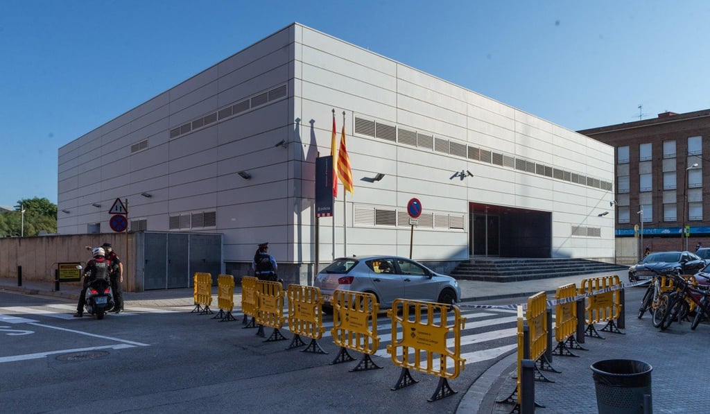 Several fences block the access to a regional police of the town Cornella, Spain after the police shot dead a man who entered in the building holding a knife on Monday. Photo: EPA-EFE