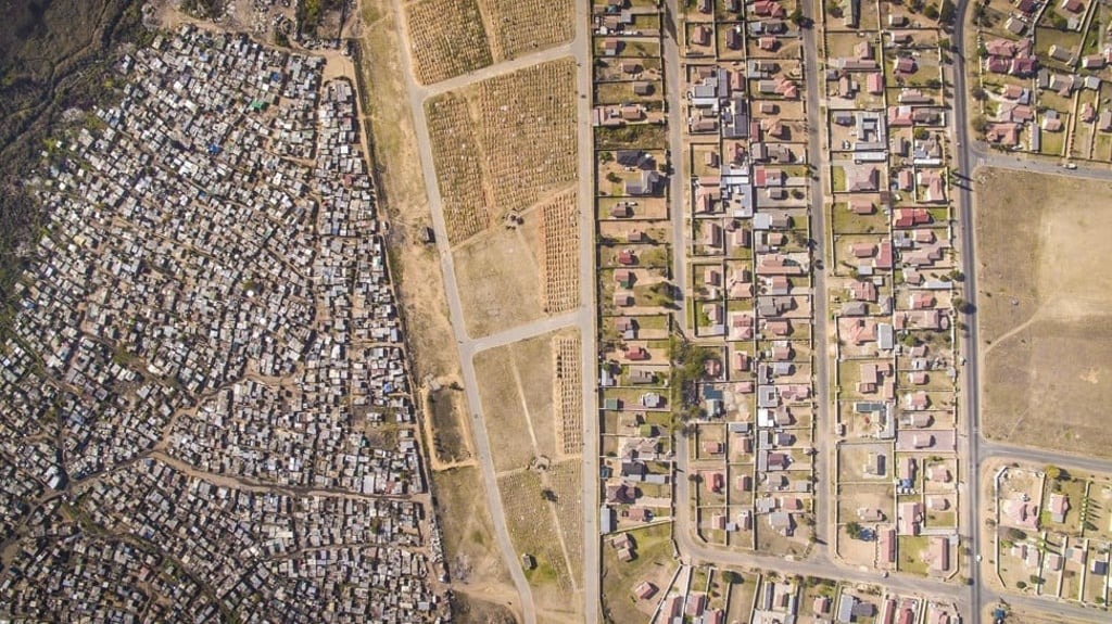 The cramped shacks which house than 30,000 poor South Africans, located in the informal settlement of Vusimuzi (left), close to wealthier developments just a stone’s throw away in the township of Tembisa, in the northern province of Gauteng.