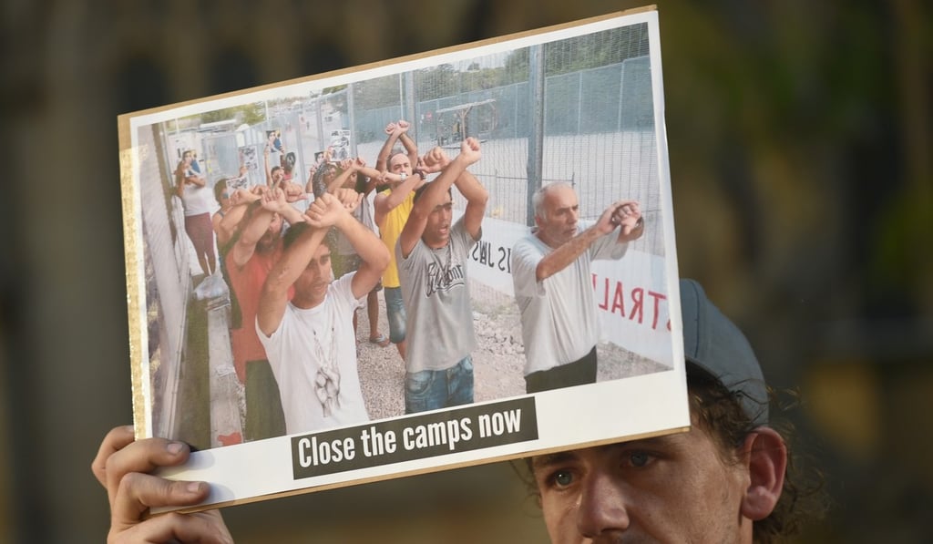 A refugee supporter holds a placard in Sydney. Photo: AFP