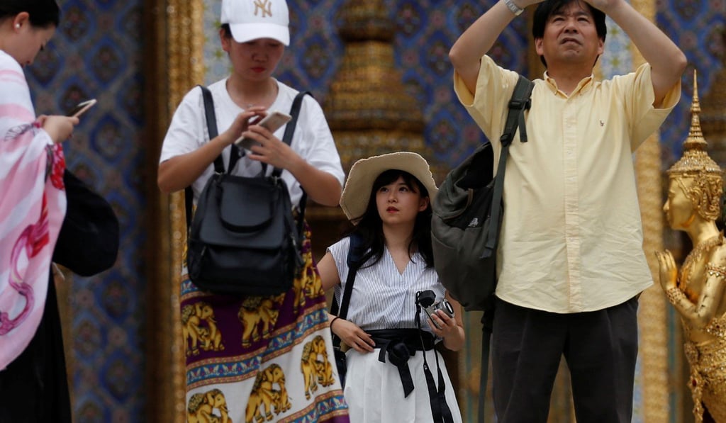 Chinese visitors at the Temple of the Emerald Buddha in Bangkok. Photo: Reuters