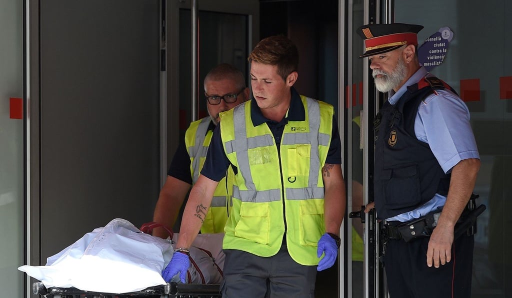 The body of Abdel Wahab Taib, who tried to attack a Spanish police station on Monday, is removed from the station after an officer fatally shot him. Photo: AFP