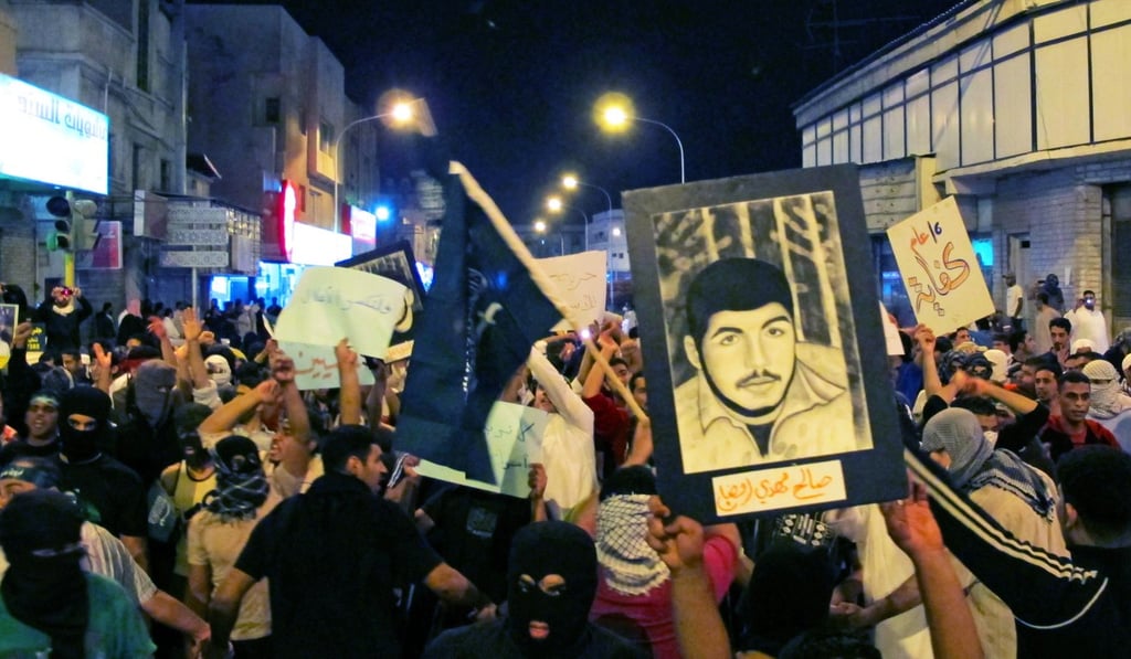 Protesters chant slogans and hold poster of jailed demonstrators during a protest in Qatif, in Saudi Arabia’s Eastern Province on March 9, 2011. Photo: Reuters