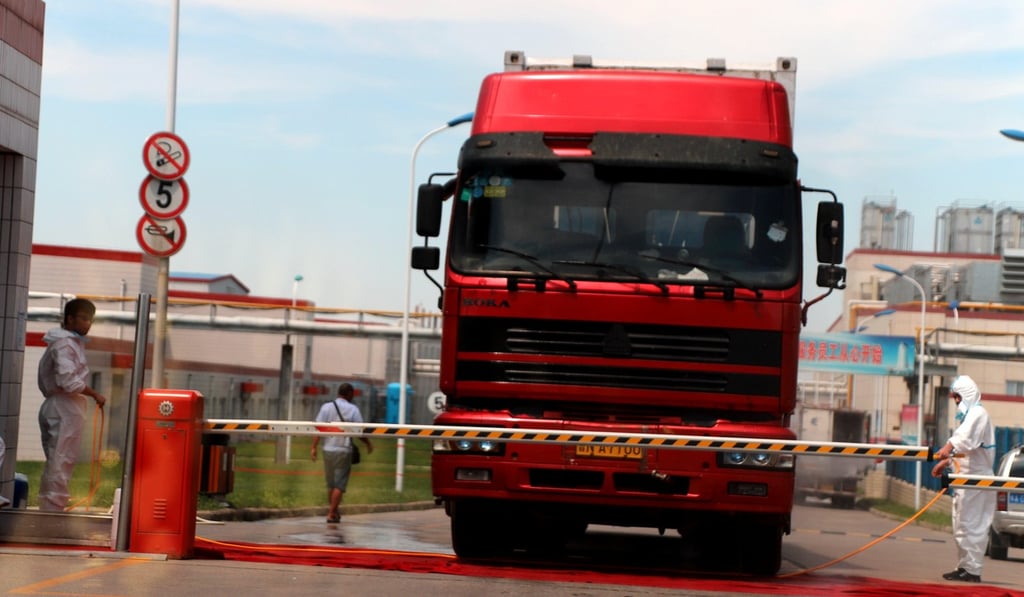 Workers wear protective suits at a pork processing plant after a discovery of pigs infected by ASF. Photo: Reuters