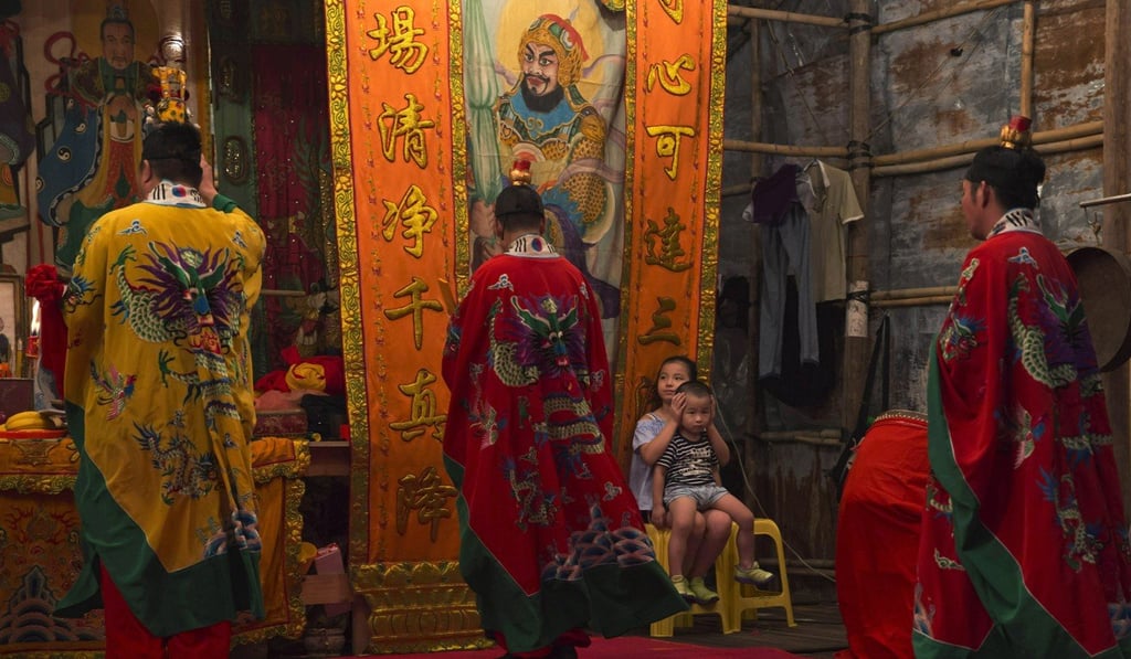 Taoists attend a service at a makeshift theatre during the Hungry Ghost Festival in Hong Kong. Hungry and restless ghosts are roaming the city and the world, visiting their living relatives, according to Chinese beliefs. Photo: AP