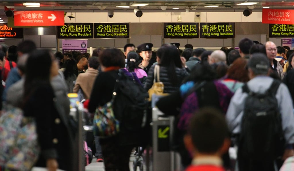 Travellers cross the border at Lo Wu. With 150 one-way permits being issued every day, the influx of immigrants into Hong Kong intensifies competition for housing. Photo: Felix Wong