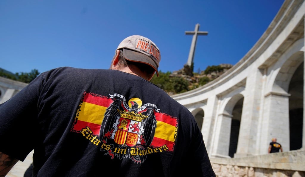 A Franco supporter outside the giant mausoleum holding his remains. Photo: Reuters
