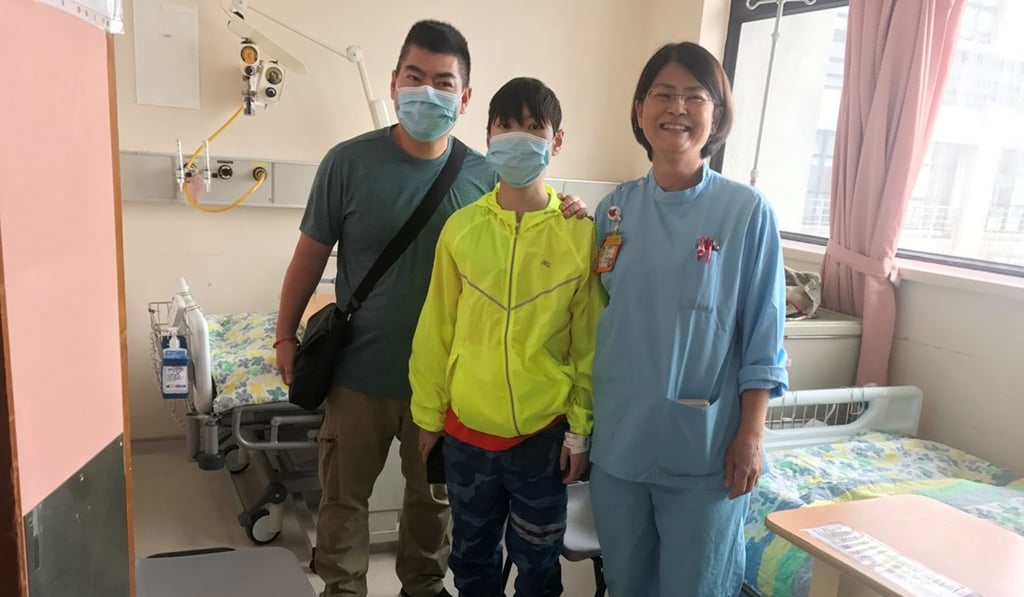 Yeung Chin-kwun (centre) with his father and nurse specialist at Queen Mary Hospital, where the surgery was performed. Photo: Handout