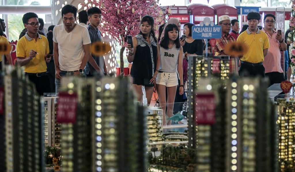Potential buyers looks at scale model of Forest City residences in the state of Johor, Malaysia. File photo: EPA