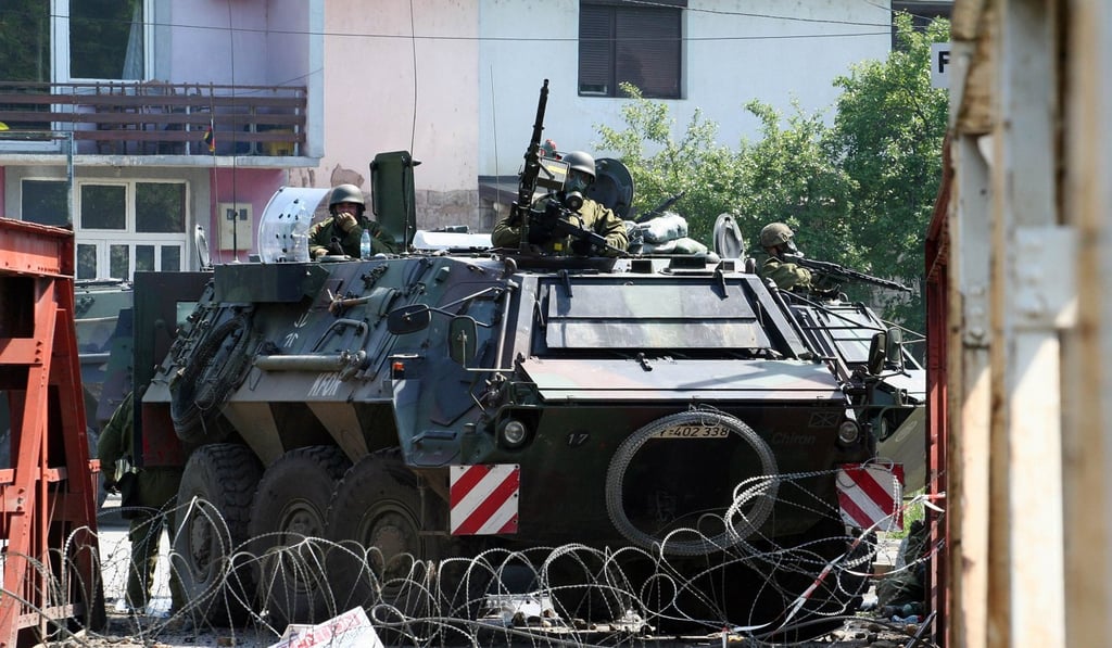 Troops on a German armoured vehicle guard a bridge entrance in the village of Rudare, near the Northern Kosovo town of Zvecank, in 2012. Photo: Agence France-Presse