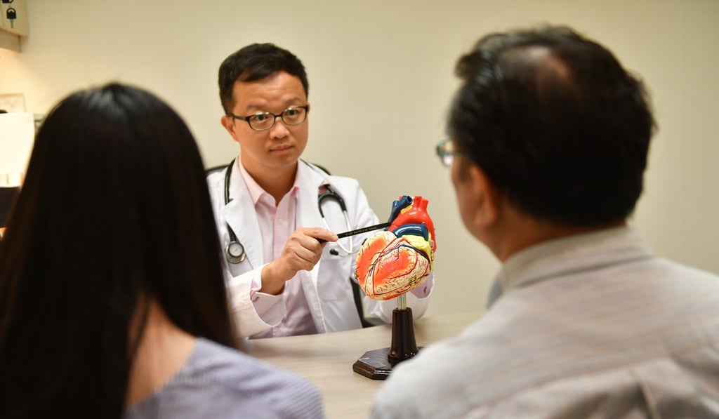 Dr Eddie Cheung (centre), assistant medical director of the Adventist Heart Fund, chats to Marfan syndrome sufferer Lai Sai-yu (left) and her father, Lai Chi-leung, during one of her regular health check-ups. Photo: Ali Ghorbani