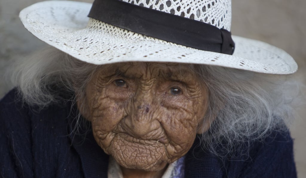 In this August 23, 2018 photo, 117-year-old Julia Flores Colque eyes the camera while sitting outside her home in Sacaba, Bolivia. Photo: AP In this August 23, 2018 photo, 117-year-old Julia Flores Colque eyes the camera while sitting outside her home in Sacaba, Bolivia. Photo: AP