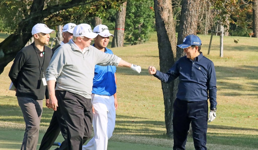US President Donald Trump and Japanese Prime Minister Shinzo Abe play golf. Photo: Kyodo via Reuters