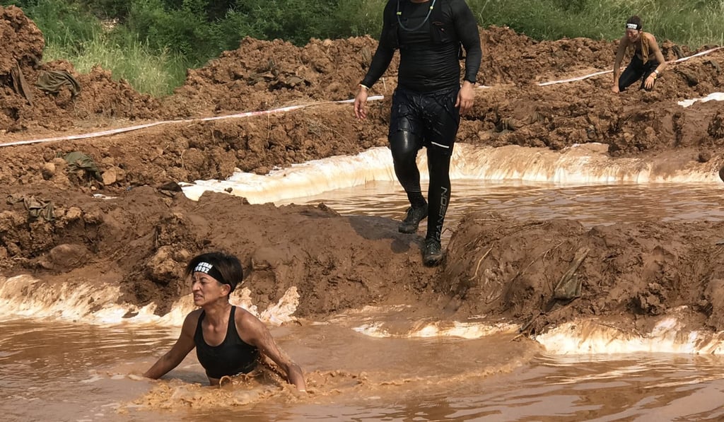 Hong Kong’s Lena Tsang wades through a muddy pool at the Spartan Race Beijing. The 42-year-old won her category in the 2018 Spartan China Female Championship. Photo: courtesy of Lena Tsang