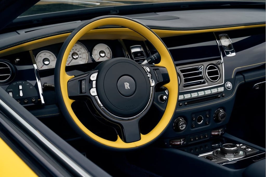 The yellow customised steering wheel contrasts with the ‘Pikes Peak’ dark navy blue of the dashboard. Photo: Rolls Royce Motor Company
